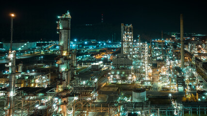 Fototapeta na wymiar cityscape night scene shot oil storage tank and oil refinery factory zone, global business and industry about natural resources wasteful for transportation and trading, aerial view