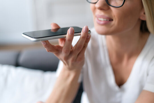woman recording voice message on cell phone