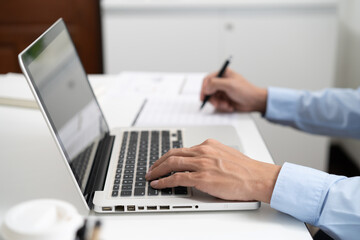Business man working by using laptop computer Hands typing on a keyboard. Professional investor working new start up project. business planning in office. Technology business