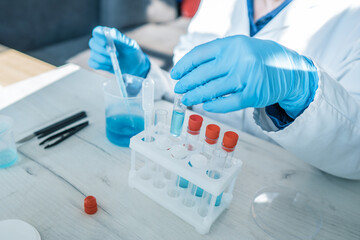 Medical research laboratory. A scientist works with a pipette and a test tube. Scientific laboratory of biotechnology, development of medicine and research in chemistry, biochemistry and experiments.