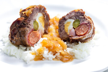 beef roulade filled with egg, sausage, bacon and prickle served with rice