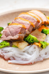 baked duck breast with vegetables and rice noodles