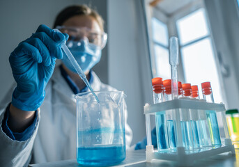 Medical research laboratory. A scientist works with a pipette and a test tube. Scientific laboratory of biotechnology, development of medicine and research in chemistry, biochemistry and experiments.