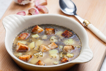 garlic soup with toasted bread and potatoes