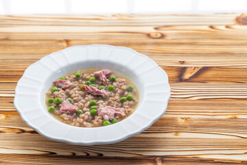 smoked meat with groats and green peas