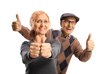 Senior man standing behind a woman and gesturing thumbs up