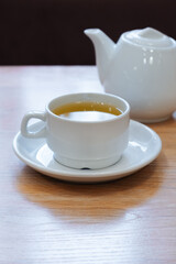 A cup of tea on the table, tea, and a teapot. Tea ceremony.