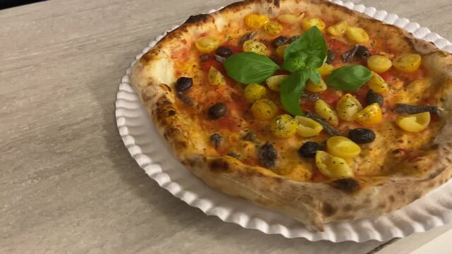 Super marinara pizza. Topping of yellow cherry tomatoes, Taggiasca olives, Cetara anchovies, capers and San Marzano tomato sauce. Very pronounced crust in a contemporary Neapolitan style.