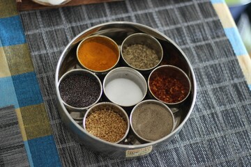 Top view of an Indian traditional masala box with various spices