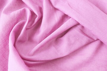 Texture of pink natural fabric, cotton, folds, top view, background for romantic congratulations, emotion of love