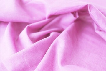 Texture of pink natural fabric, cotton, folds, top view, background for romantic congratulations, emotion of love