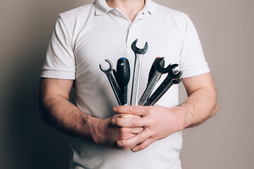 Man with bouquet of wrenches, spanners and screwdrivers. Father's Day concept