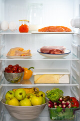 Refrigerator with healthy food. Refrigerator with meat, fish, chicken, red caviar, steaks, vegetables, fruits, eggs. Fridge full of healthy food only. Diet with protein. Refrigerator with protein diet