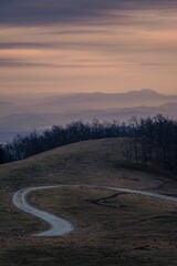 Aerial view of Appalachian mountain landscape surrounded by growing dense trees during sunset