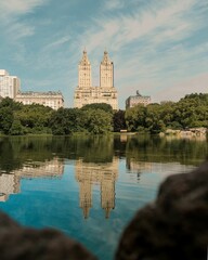 Fototapeta na wymiar Vertical shot of the San Remo reflecting on the water surface on a sunny day in New York City