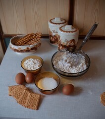 Preparing cake, with flour, eggs, milk and cookies