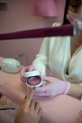 Manicure center with assistant and client, with horizontal wax bar, showing colors