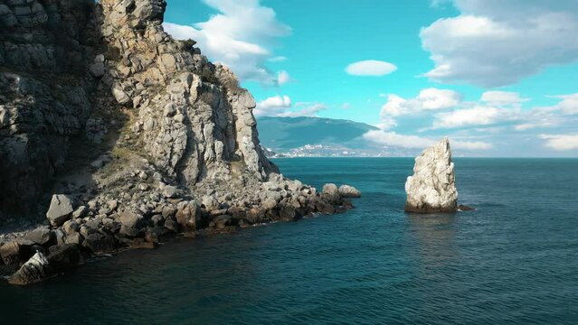 beautiful seashore of the Crimean peninsula in spring , rocks and sea against the sky and clouds