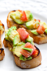 bruschetta with chopped tomatoes and avocado