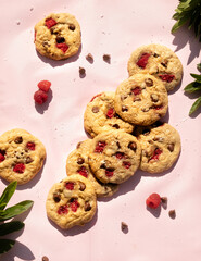 raspberry and chocolate chip cookies on a pink background