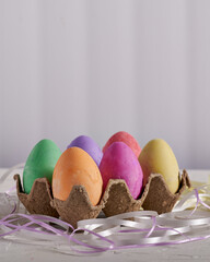 easter eggs in an egg tray, colorful  easter eggs