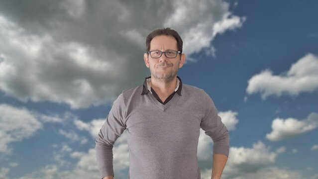 Caucasian man wearing eyeglasses, smiling and posing with self-confidence isolated on clouds