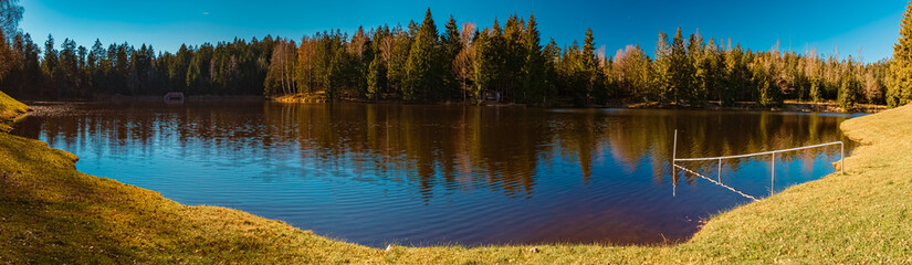 Obraz premium High resolution stitched autumn or indian summer panorama with reflections at Riedelsbach reservoir, Neureichenau, Bavarian forest, Bavaria, Germany