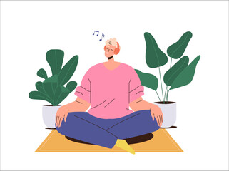 Happy smiling guy wearing wireless earphones headset listening to music sitting on floor at home