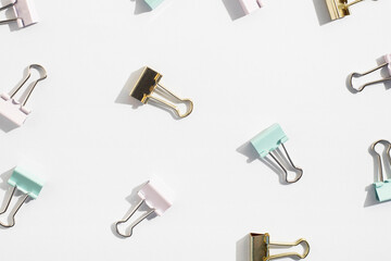 Stationery, clips, paper clips on a white background. Top view, flat lay