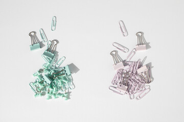 Stationery, paper clips, binders, buttons on a white background. Top view, flat lay