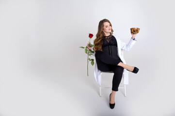 attractive holds a skull in her hands concept of photography is suitable in the field of cosmology, medicine and healthcare Woman in a white robe and black evening dress beautiful bright fierce