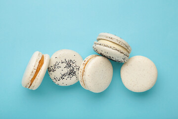 Cake macaron or macaroon on blue background. Space for text