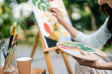 Female artist painting art canvas drawing with inspiration in garden art therapy creativity...
