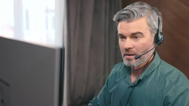 Busy attractive manager making professional consulting clients in office. Caucasian broker support customers on headset. Call-center service, digital currency, investor, support operator.