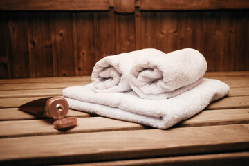 Traditional wooden sauna for relaxation with a set of clean towels