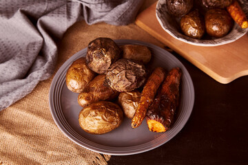 Baked vegetables - carrots, potatoes, beetroot. Whole food diet, Mediterranean diet, vegan food concept.