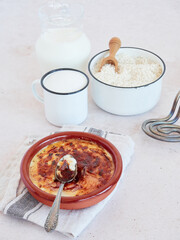 Rice pudding Asturian traditionally style. Ingredients for recipe preparation and a ready to eat...