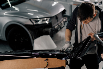 Gluing the film on the spoiler to protect the paint which protects the paint from scratches and stones auto detailing