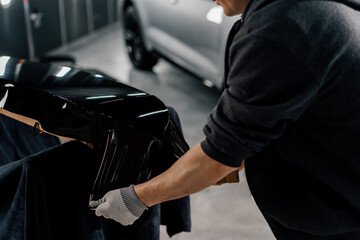 Gluing the film on the spoiler to protect the paint which protects the paint from scratches and...