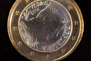 Close-up of a two-euro coin. Close-up of two euro coins on the table. Euro coin with selective focus