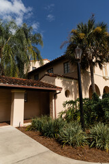 green palm trees near luxurious Mediterranean style house in Miami.