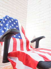 the concept of the presidential election in america the american flag on an empty chair