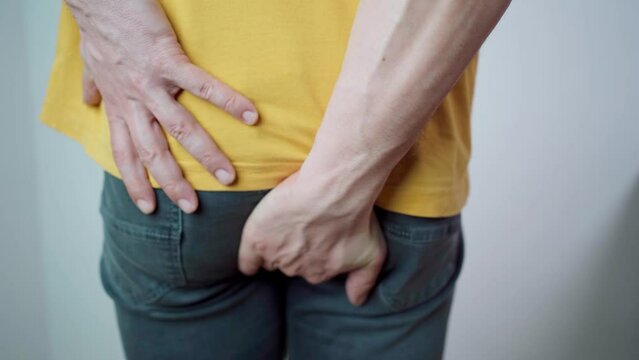 4K video footage of a middle aged man has pain in the butt, Hemorrhoids, Anal disorders.
