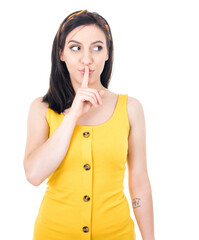 Psst. Young woman holding finger on lips, keep the secret concept, isolated on white background