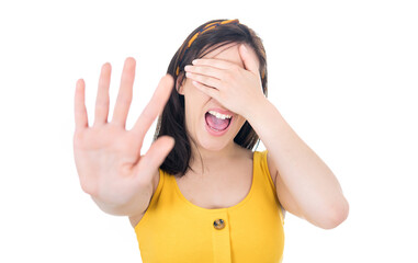 Don't come in any closer. Woman covering face and eyes with hand. Gesture with fear face...