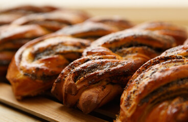 Puff pastry with poppy seeds prepared in a bakery for lunch. Tasty sweet bread products