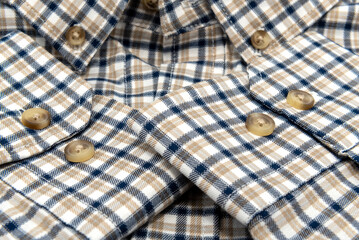 Men's shirt. Plaid shirt sleeve with buttons. Piece of clothing. Button