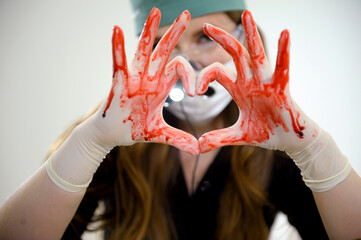 show with hands heart on hands blood flows in trickles dental binoculars on the doctor's nose...
