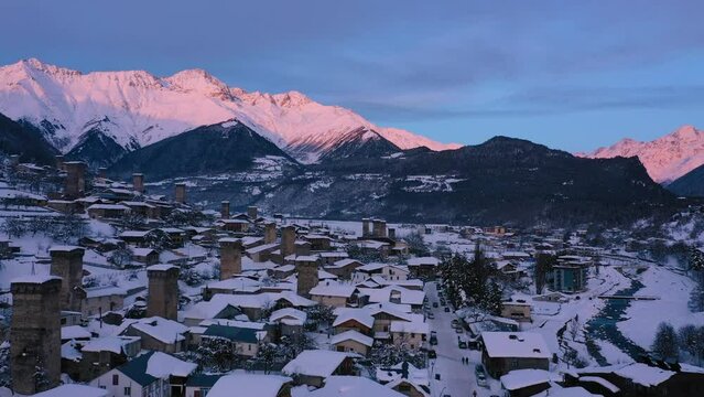 Small town in winter in a stunning mountain valley aerial view, done video. Mestia Svaneti Georgia