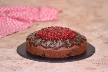 Traditional homemade chocolate cake with chocolate glaze and cherry on top.